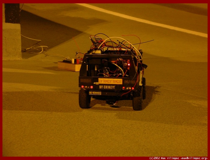 A close-up picture of the rear of the remote controlled car with all the wires hanging off