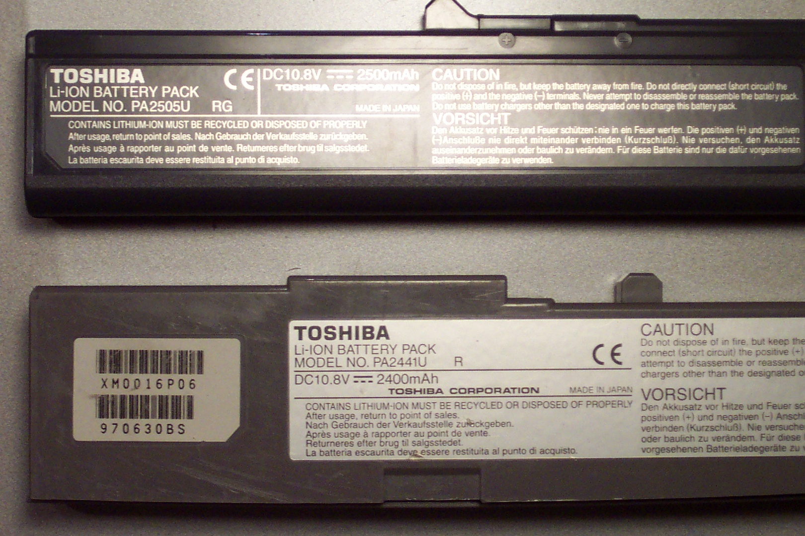 A close up of two laptop batteries, Toshiba Li-Ion battery pack model numbers PA2505U and PA2441U