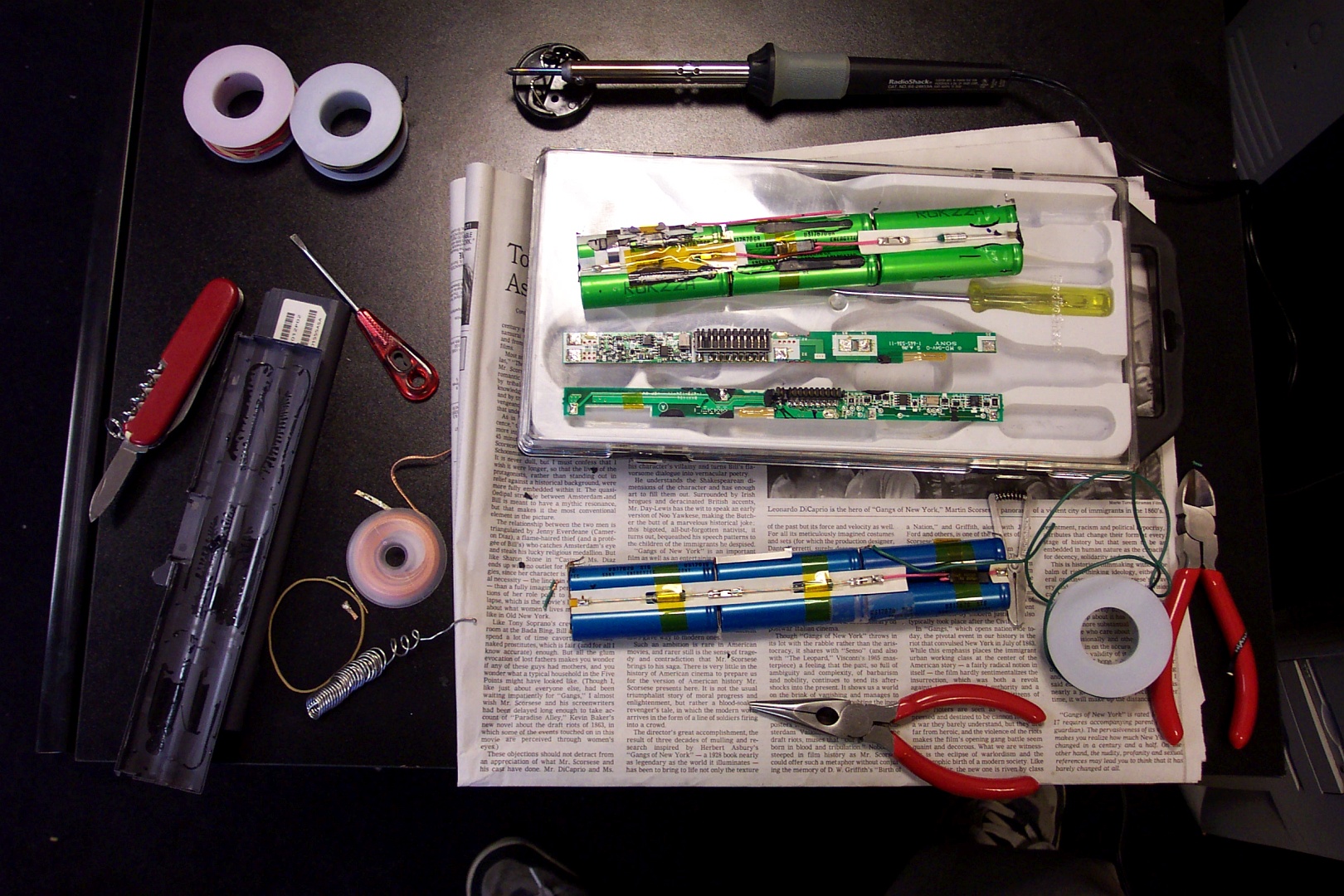 The two laptop batteries, disassembled, with the battery management system circuit boards removed from the battery cells.