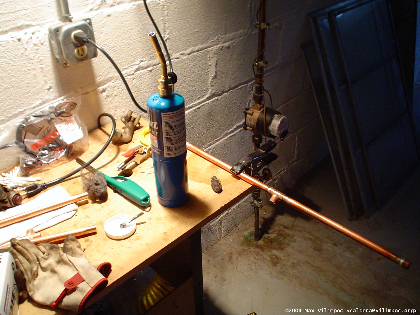 Soldering the copper pipe using the propane torch, a view of the workbench in the basement