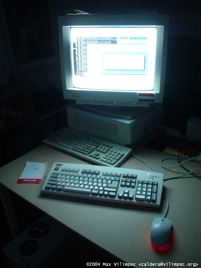 The PowerMac 7200 connected to the keyboard and mouse, a large monitor sits atop the computer and is on, and shining bright white