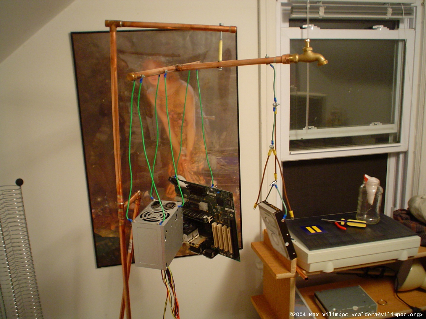 The computer being reassembled in the attic workroom, with parts hanging off the main horizontal arms
