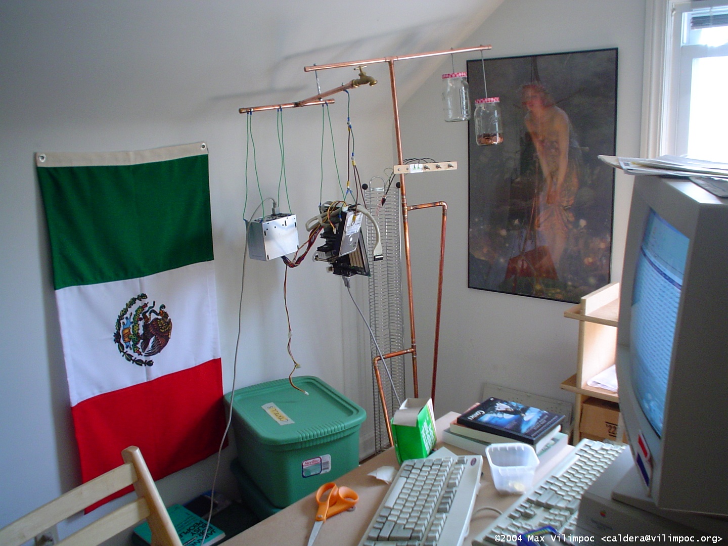 Another view of the fully assembled hanging computer in the attic workroom, with several green storage bins, and a Mexican flag made of cloth
