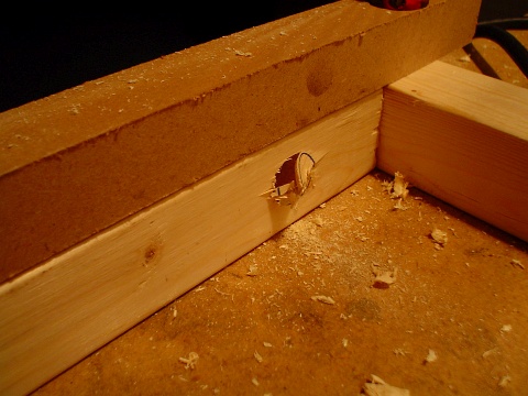 Three quarter inch holes drilled through the wooden support frame