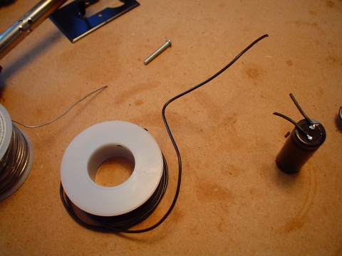 A coil of black signal low-voltage signal wire and a large capacitor