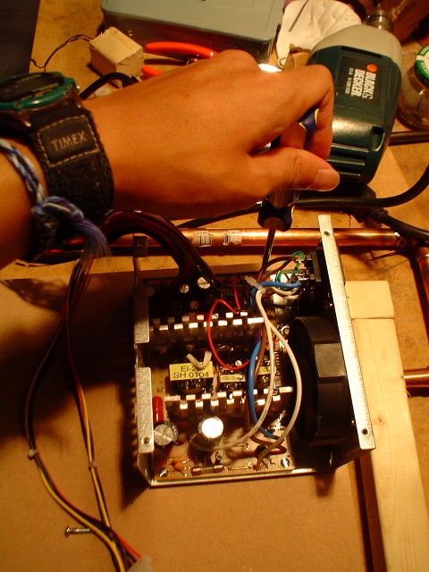 Attaching the ATX power supply to the piece of middle-density fiberboard