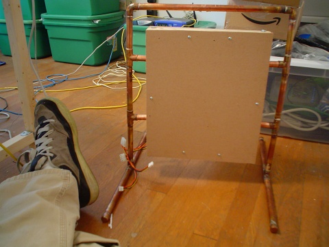 Sitting on the floor looking at the support frame built from copper tubing, with no components mounted
